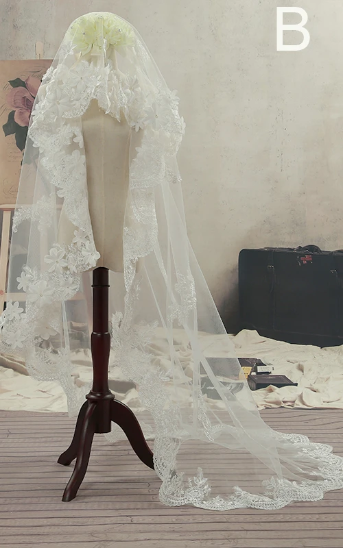 Voile de mariée en tulle à balayage simple, bordé de dentelle et orné de fleurs.