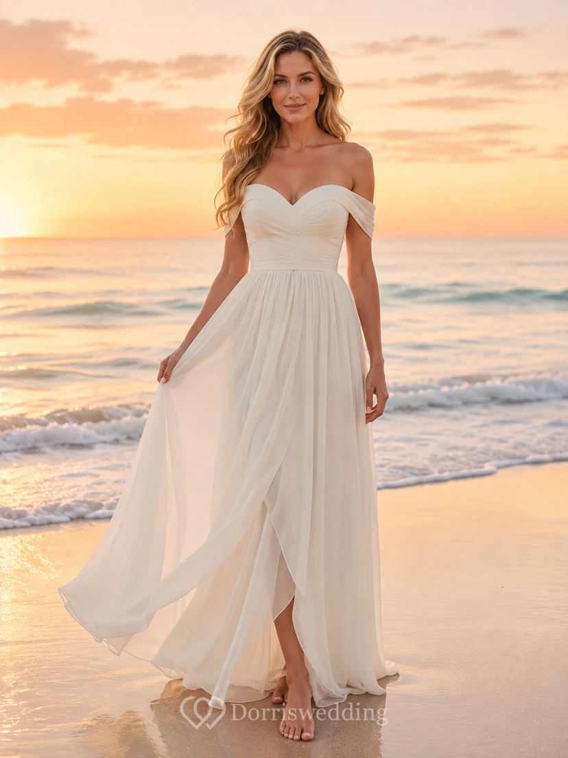 Robe de mariée trapèze en mousseline à épaules dénudées et décolleté cœur, idéale pour une cérémonie de renouvellement de vœux à la plage.