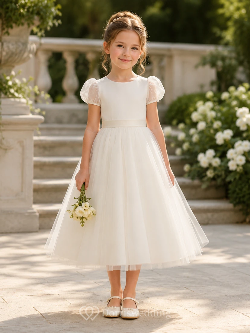 Vestido de niña de flores moderno y elegante color marfil con lazo en la espalda, corte en A, mangas cortas, cuello redondo y falda hasta la rodilla.