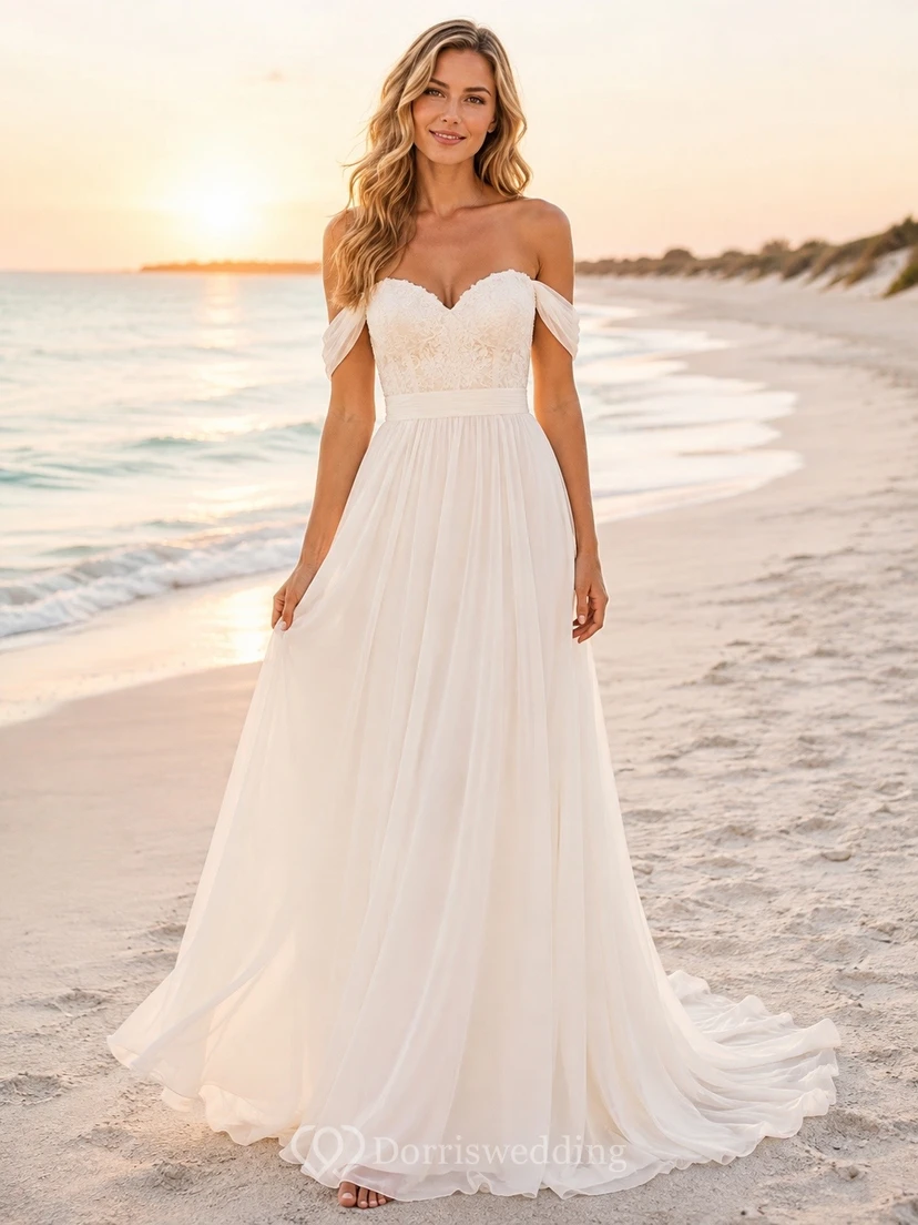 Vestido de novia de gasa con escote Bardot y cola larga, ideal para fugarse a la playa.