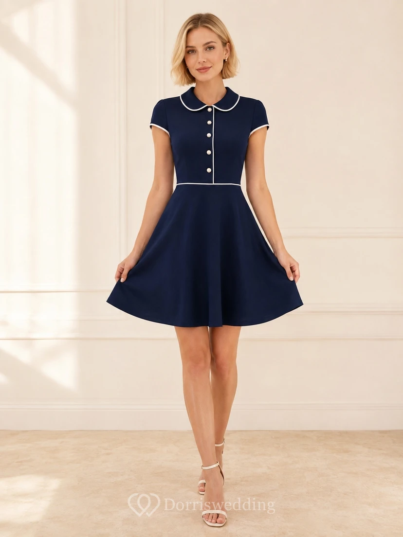 Robe de cocktail élégante bleu marine à ourlet cranté et boutons nacrés, coupe trapèze courte.