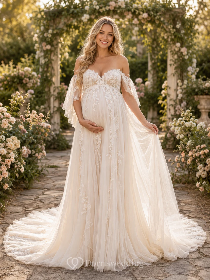 Vestido de novia premamá con hombros descubiertos, encaje, tul, estilo jardín, mangas con volantes y cola de corte.