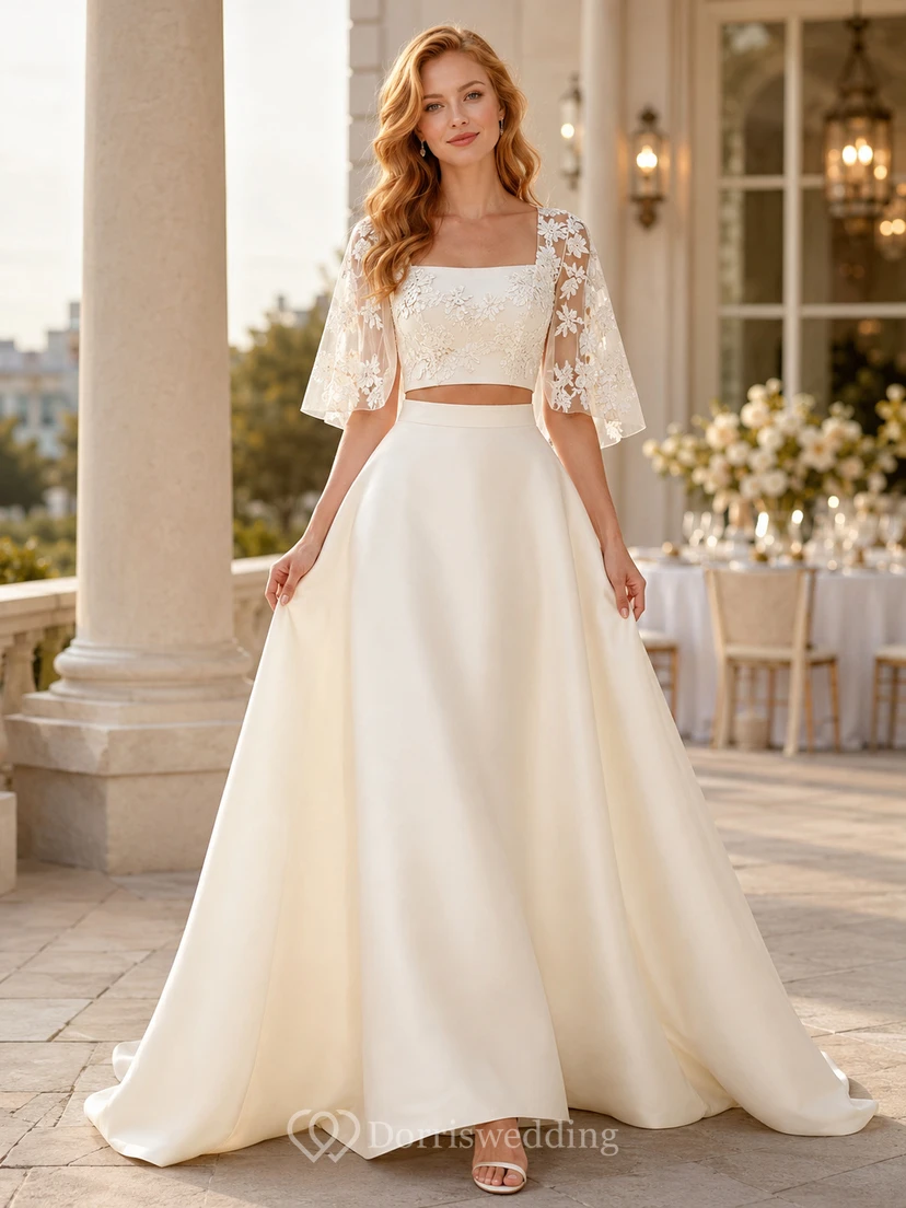Robe de bal noire deux pièces en dentelle à manches cape et nœud papillon