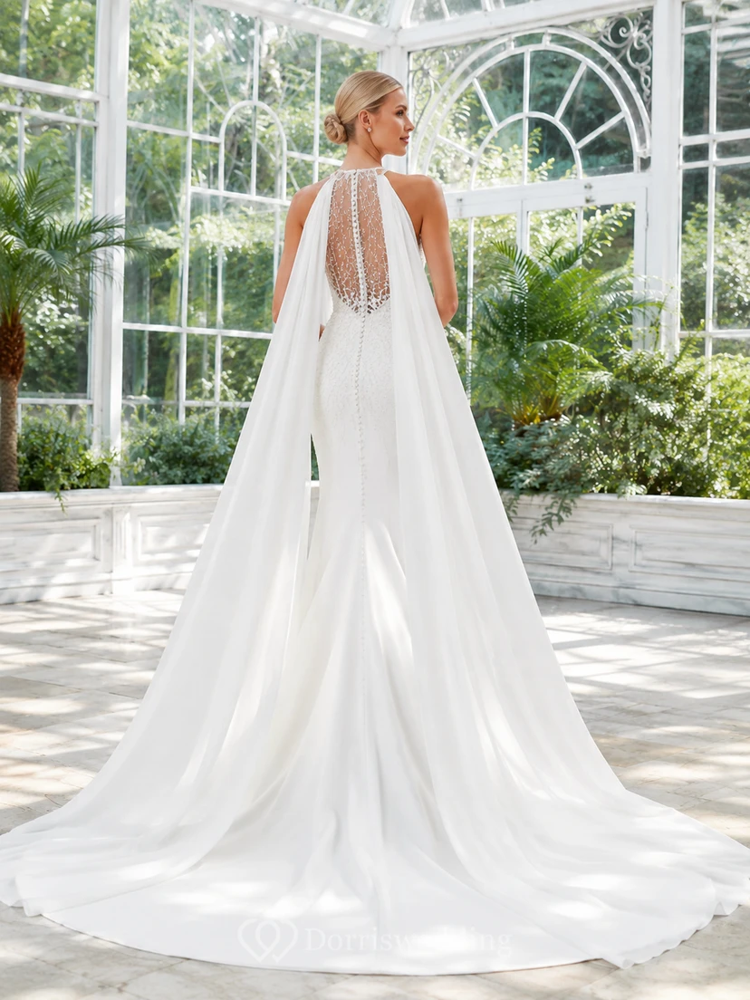 Robe de mariée fourreau en satin et mousseline de soie, col montant illusion, manches cape et traîne amovible, idéale pour une destination. view 2