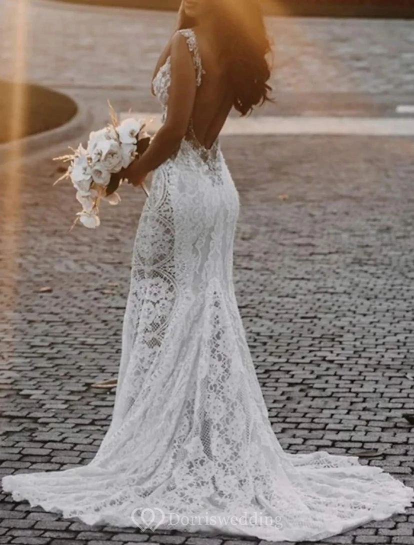 Vestido de novia bohemio de encaje estilo sirena con escote ilusión pronunciado.