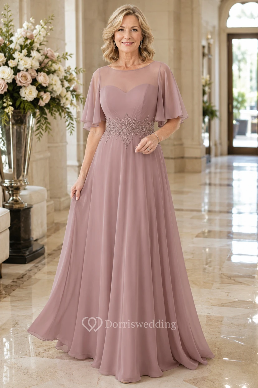 Robe mère en mousseline illusion rose poudré, coupe trapèze, avec manches cape flottantes
