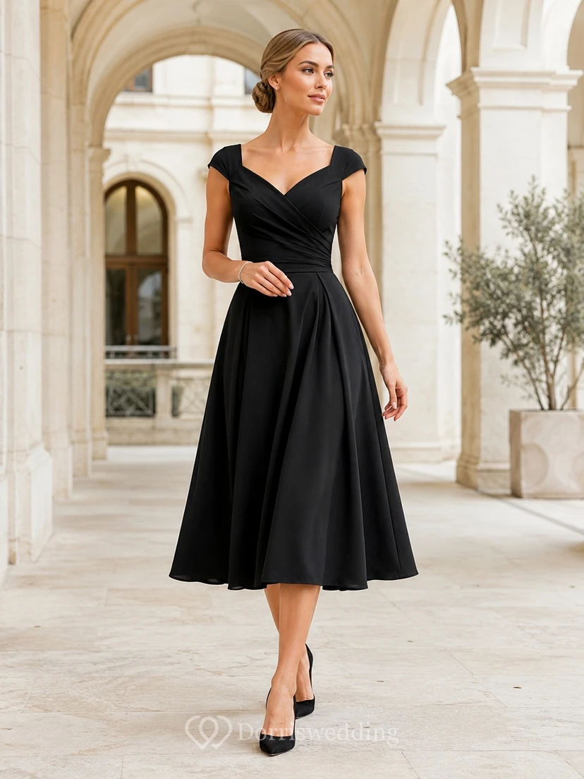 Vestido formal vintage negro de satén con escote en V y mangas cortas, corte en A y largo hasta la rodilla.
