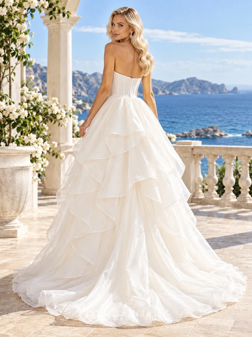 Vestido de novia asimétrico sin tirantes, escote corazón, corsé, volantes y cola en línea A view 2