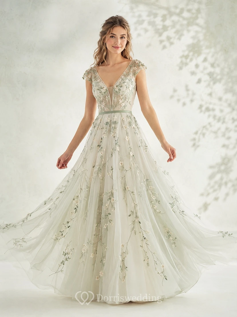 Vestido de novia bohemio de corte A con cola larga, escote en V y mangas cortas, en tul floral color celadón.