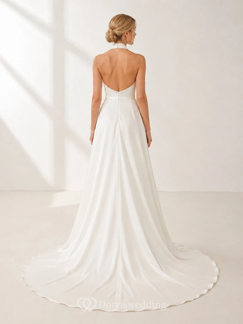Vestido de novia sencillo con escote halter, corte en A, espalda descubierta y cola larga hasta el suelo. view 2