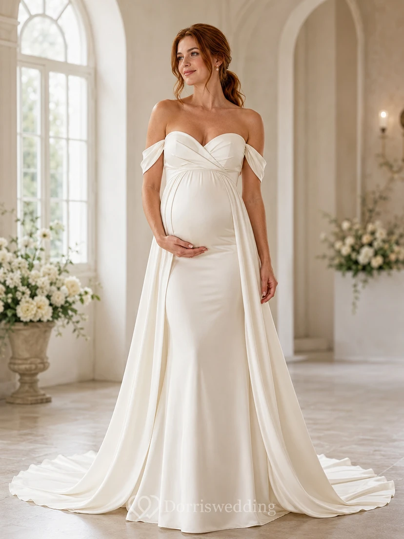 Vestido de novia premamá de satén con escote Bardot y cola drapeada.