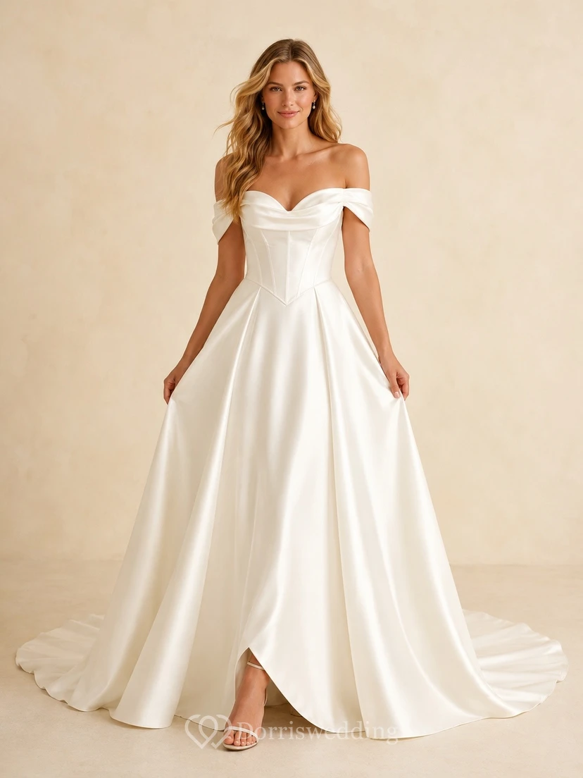 Vestido de novia de satén con mangas cortas, hombros descubiertos, corte en A y cola larga.