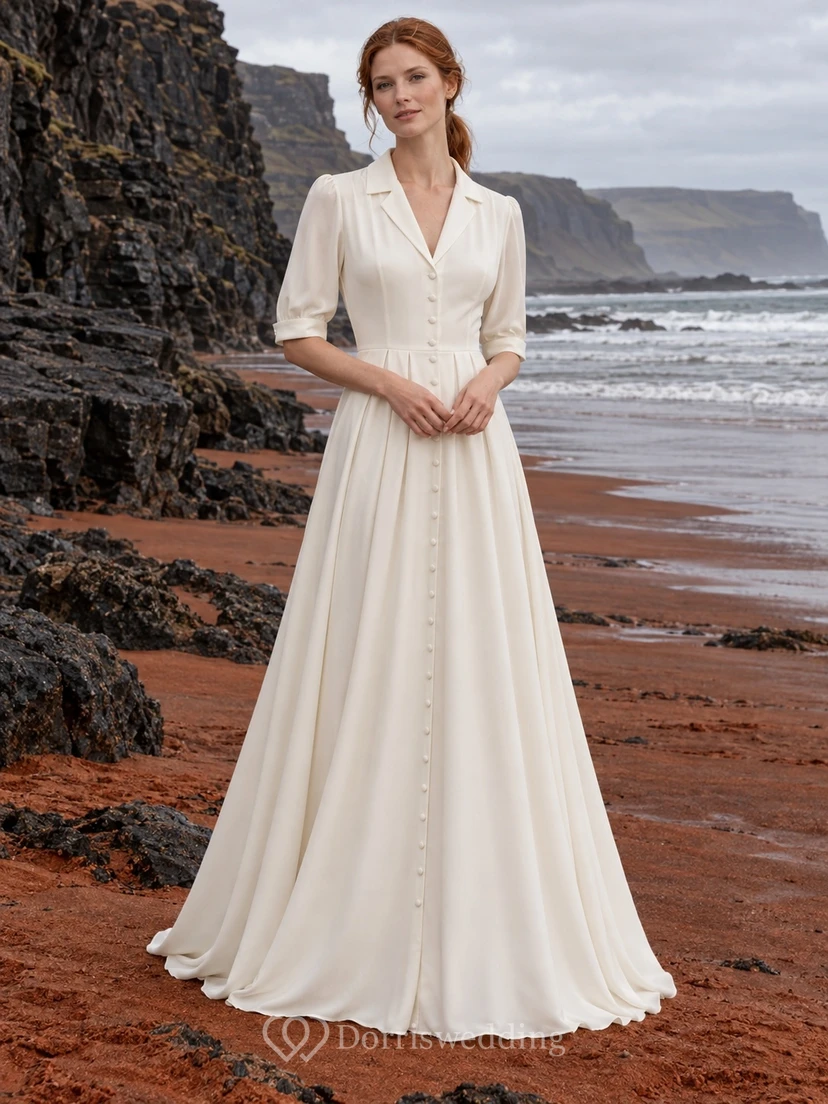 Vestido de novia de crepé de China con cuello con muescas, mangas hasta el codo y botones delanteros.