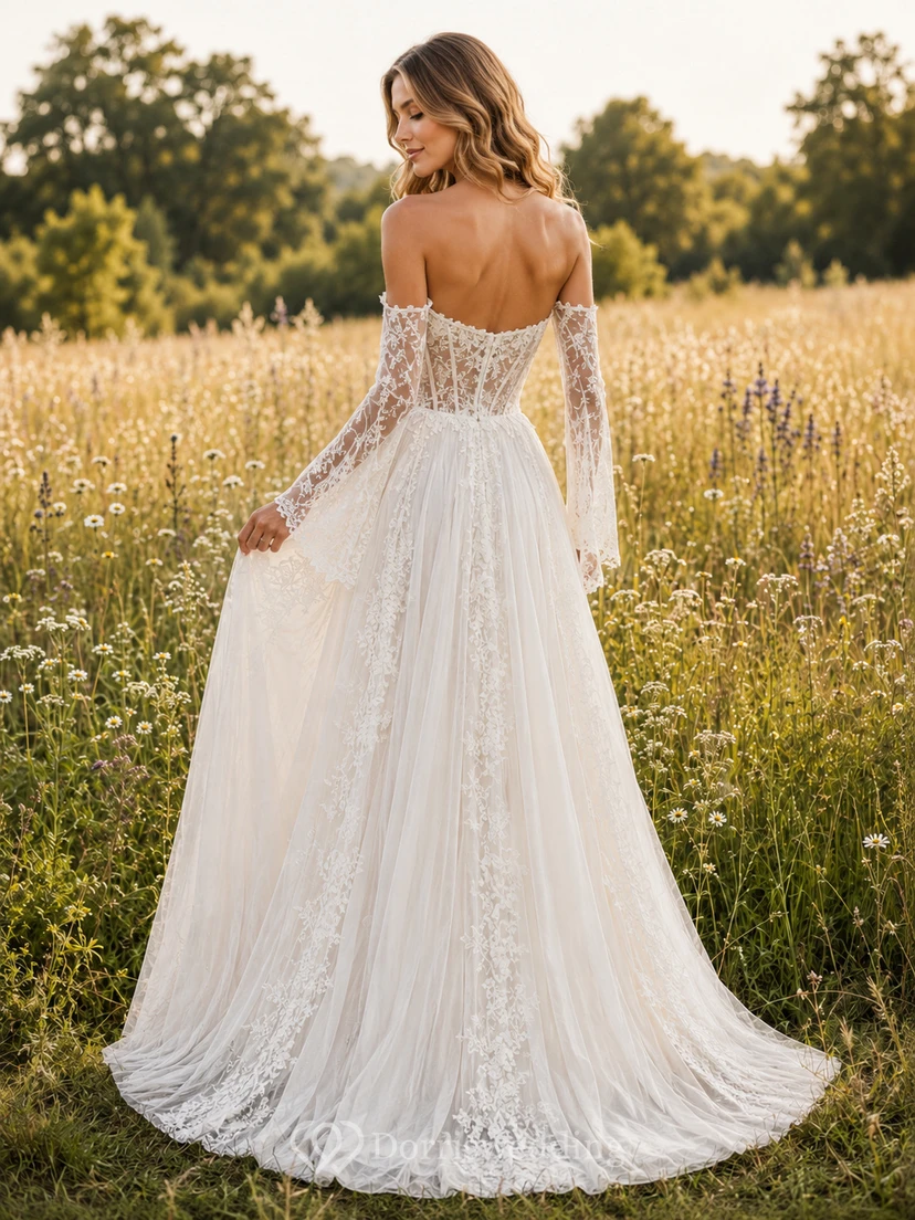 Robe de mariée longue en tulle fleuri, coupe trapèze, épaules dénudées, manches longues, ornée d'appliqués et traîne. view 2