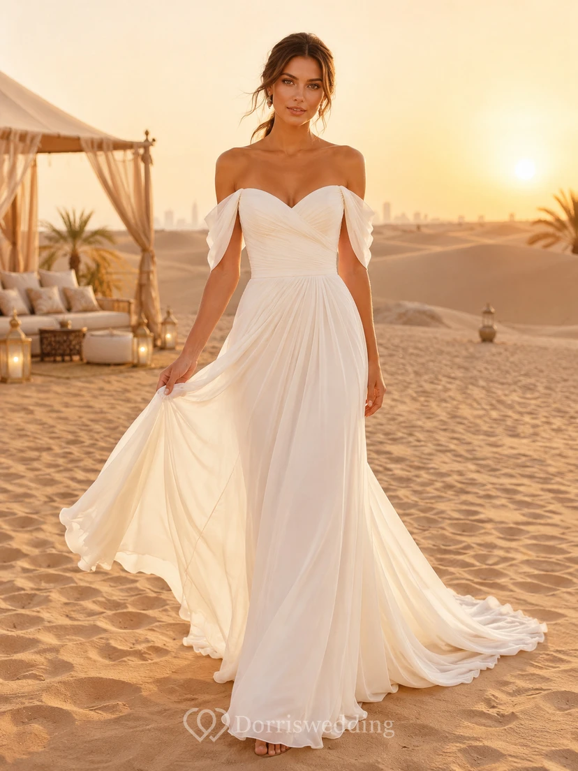Robe de mariée romantique en mousseline, coupe trapèze, épaules dénudées et décolleté cœur, idéale pour une destination de plage