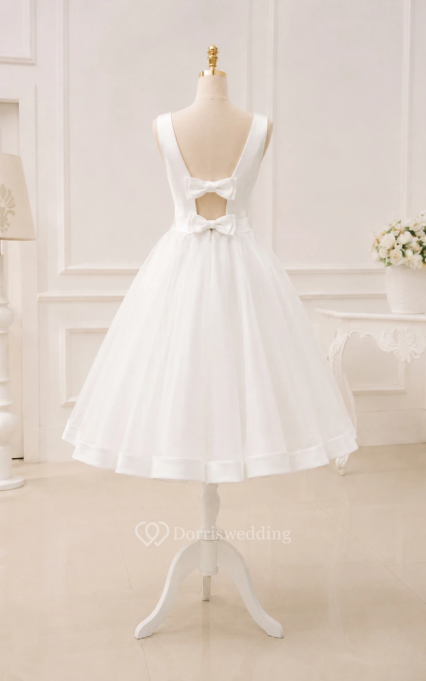 Robe de mariée blanche en organza, longueur thé, col bateau et dos nu en forme de goutte view 8