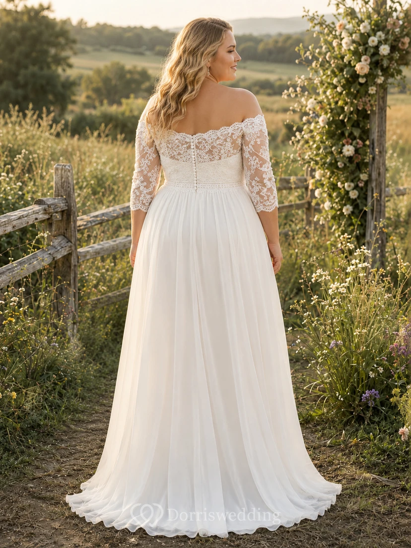 Robe de mariée en mousseline et dentelle, coupe trapèze, épaules dénudées, manches mi-longues, traîne. view 2
