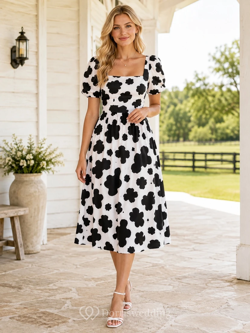 Schwarzes und weißes Landhauskleid mit Kuhmuster, quadratischen Puffärmeln, Teelänge und A-Linien-Schnitt