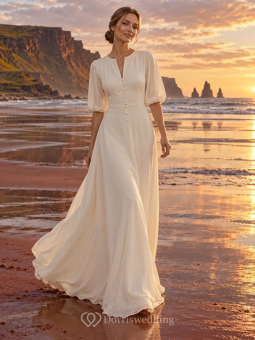 Vestido de novia de crepé de China con escote en V, mangas abullonadas y botones delanteros.