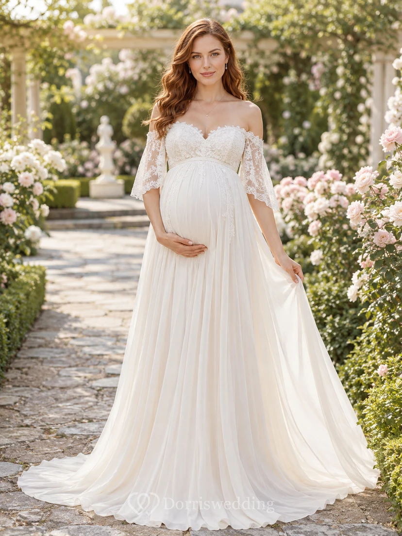 Vestido de novia premamá con hombros descubiertos, encaje y tul, corte en A, mangas con volantes y cola.