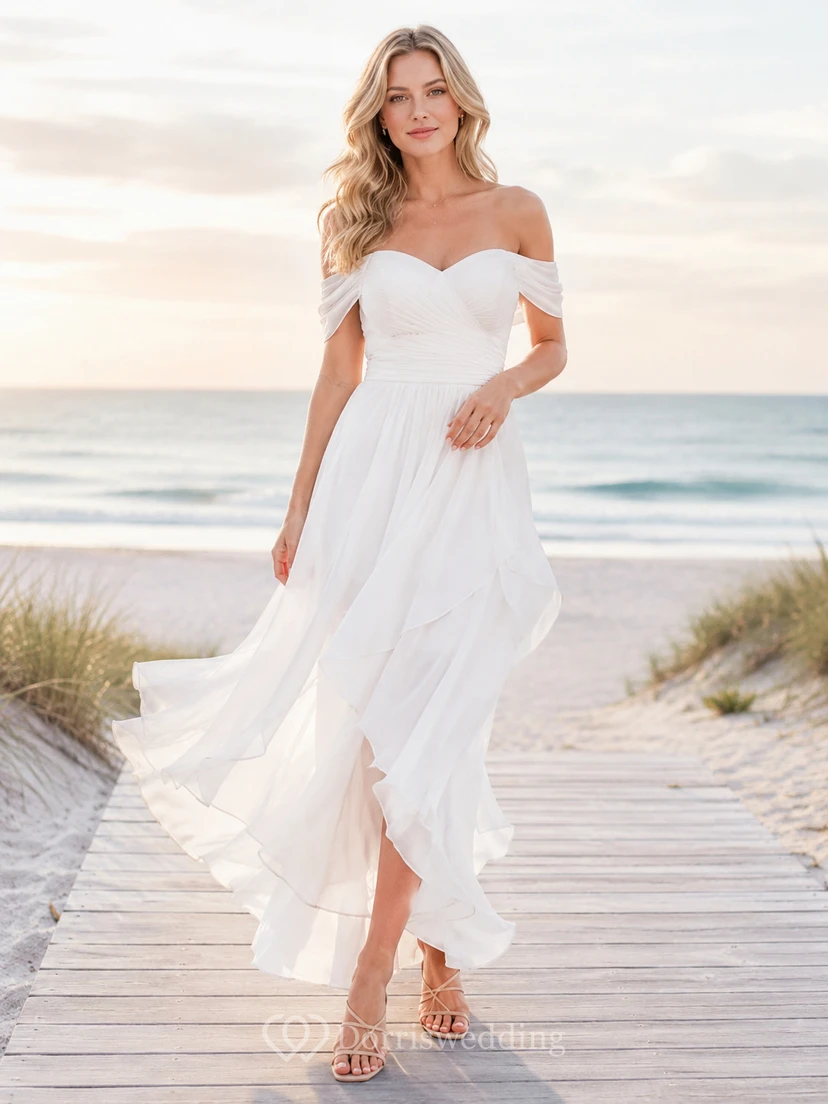 Vestido de novia bohemio romántico de gasa, corte A asimétrico, manga corta y escote Bardot, estilo bohemio, ideal para bodas en la playa.