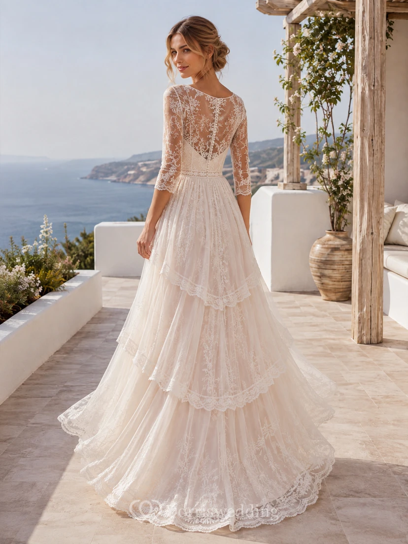 Robe de mariée longue à traîne, décolleté bateau, manches longues, dentelle illusion, tulle, volants, coupe trapèze, longueur au sol. view 2