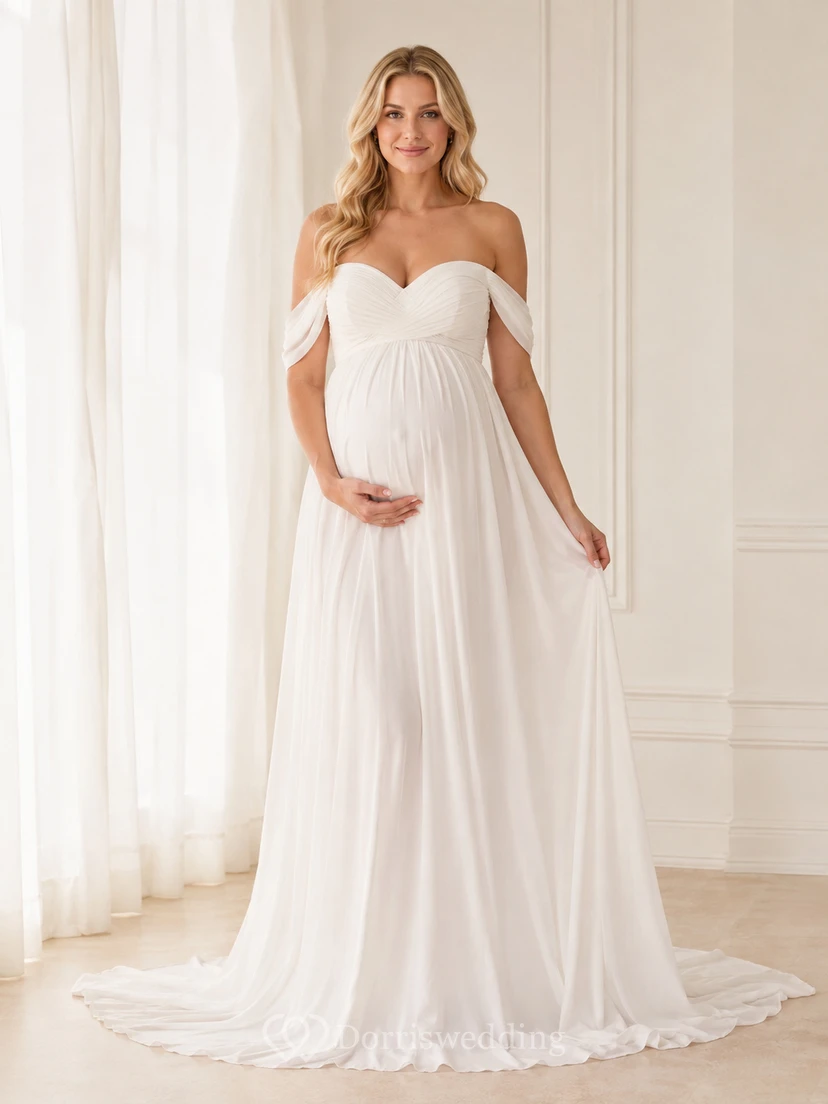 Vestido de maternidad romántico blanco de gasa con escote corazón, hombros descubiertos y corte imperio con cola.