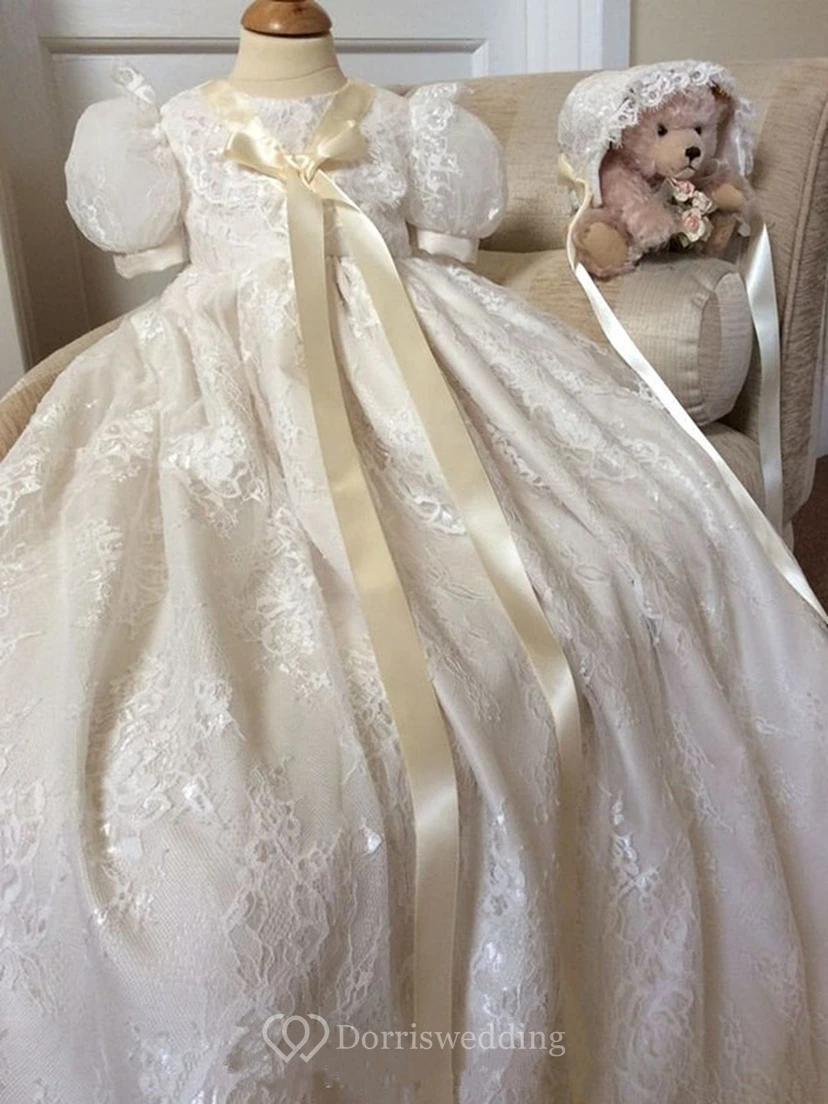 Adorable vestido de bautizo con mangas abullonadas y lazo aplicado.