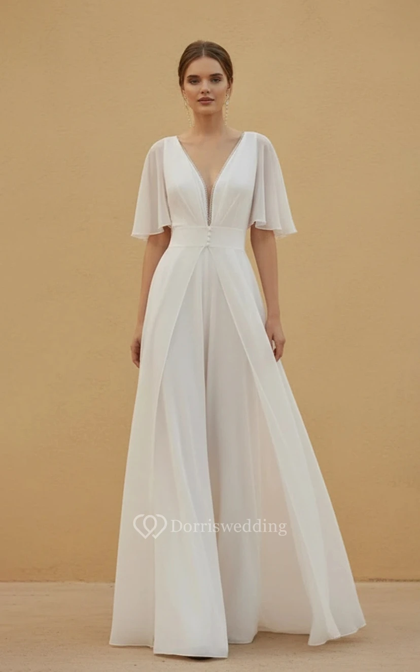 Mono de boda con escote en V, mangas cortas de tul, cintura decorada y pernera ancha.