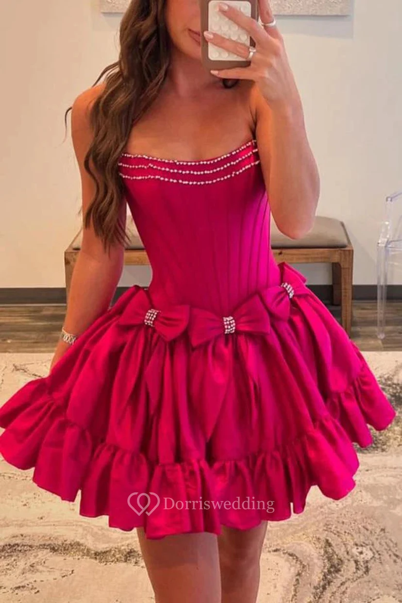 Vestido magenta sin tirantes con lazo y abalorios.