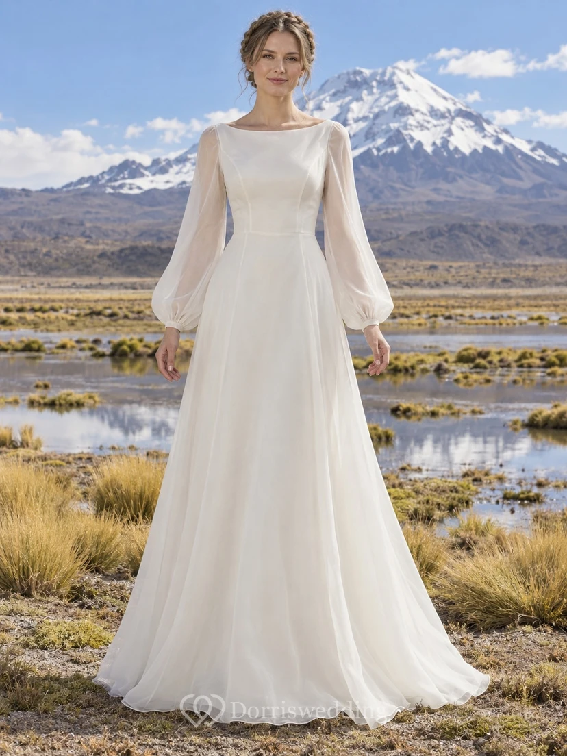 Sencillo y modesto vestido de novia bohemio de organza de manga larga con escote barco y corpiño con paneles.