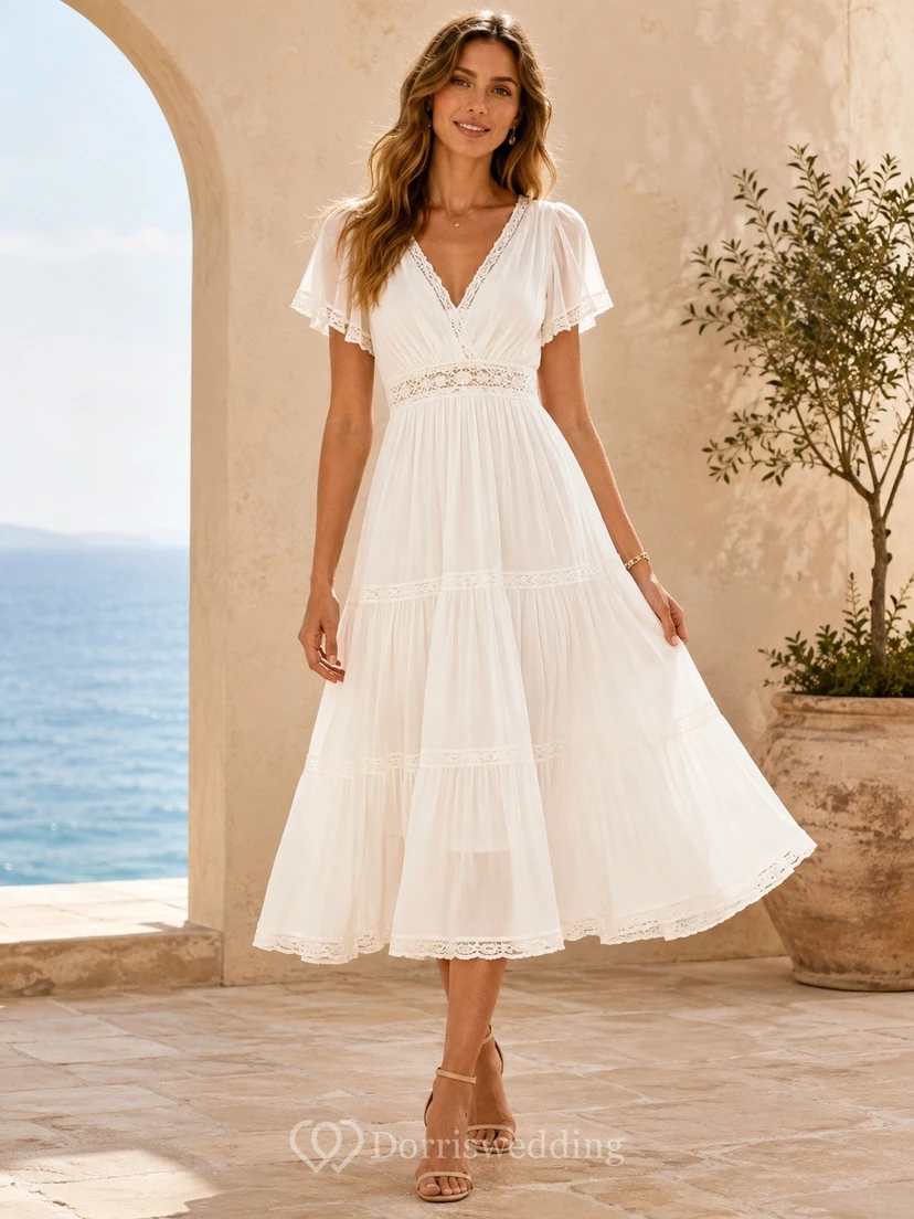 Vestido bohemio blanco de largo midi con escote en V y mangas con volantes.