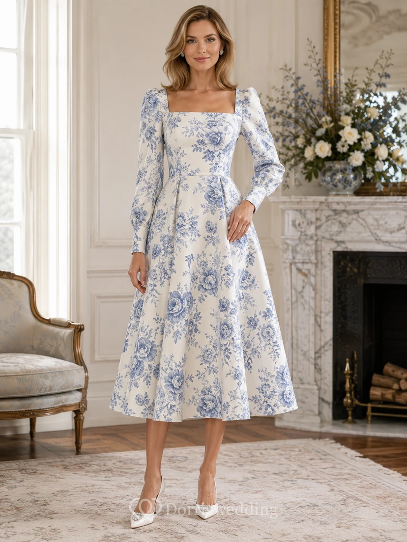 Vestido de invitada de tafetán con cuello cuadrado y mangas abullonadas, estampado floral blanco y azul.