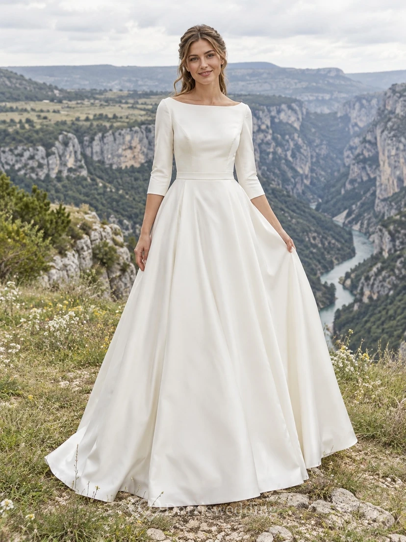 Vestido de novia sencillo de corte princesa con escote barco, mangas tres cuartos, satén duquesa y cola larga.