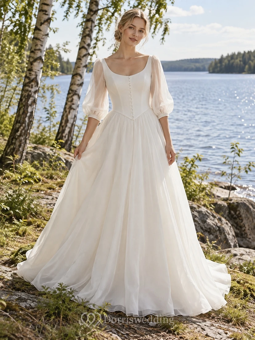 Vestido de novia vintage de organza con corte en A, escote redondo y mangas abullonadas transparentes.