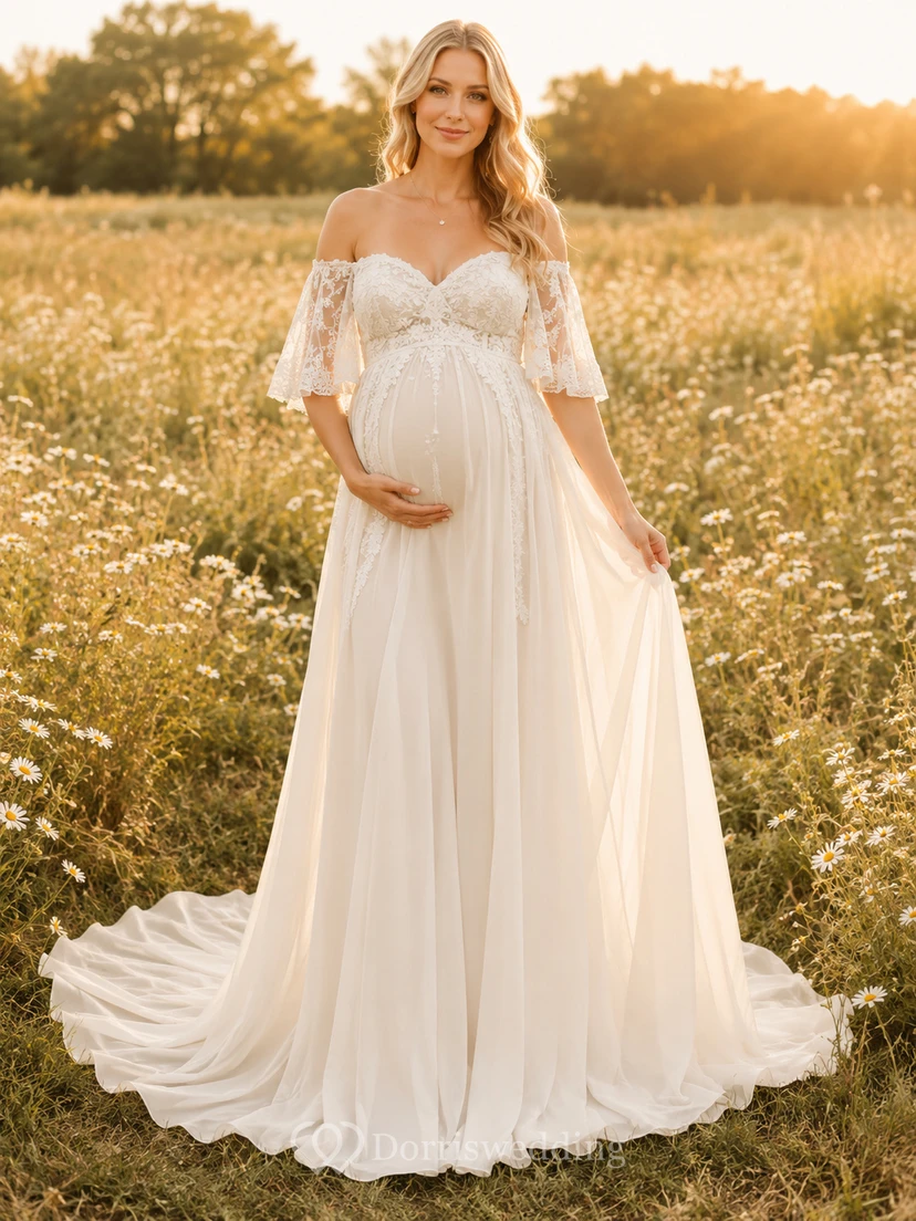 Vestido de novia premamá con escote corazón, mangas de encaje y corte en A con cola.