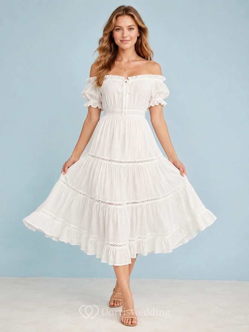 Robe mi-longue en mousseline blanche à épaules dénudées, manches bouffantes et volants