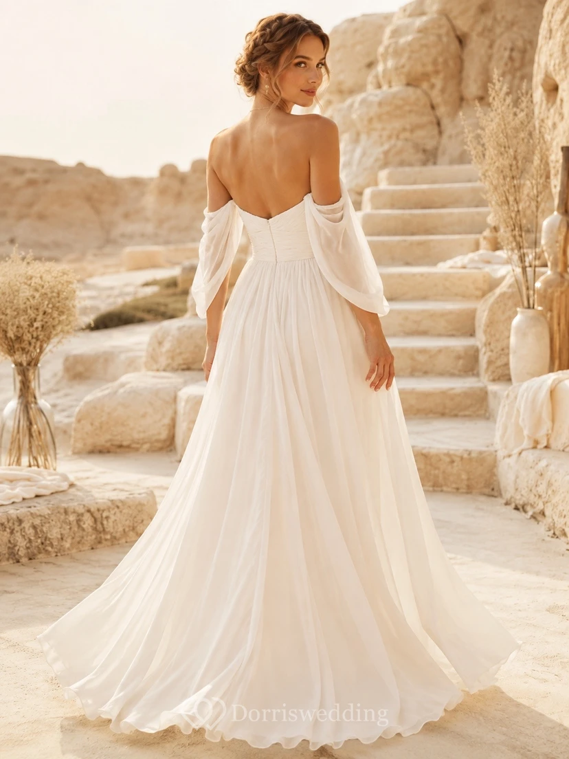Vestido de novia de gasa con hombros descubiertos y mangas cortas, estilo vaporoso, ideal para una boda íntima. view 2