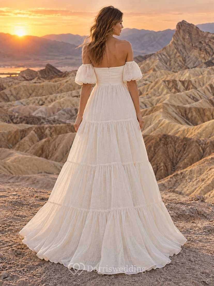 Vestido de novia sencillo de manga corta con escote Bardot y falda escalonada, confeccionado en lino, corte en A y largo hasta el suelo. view 2