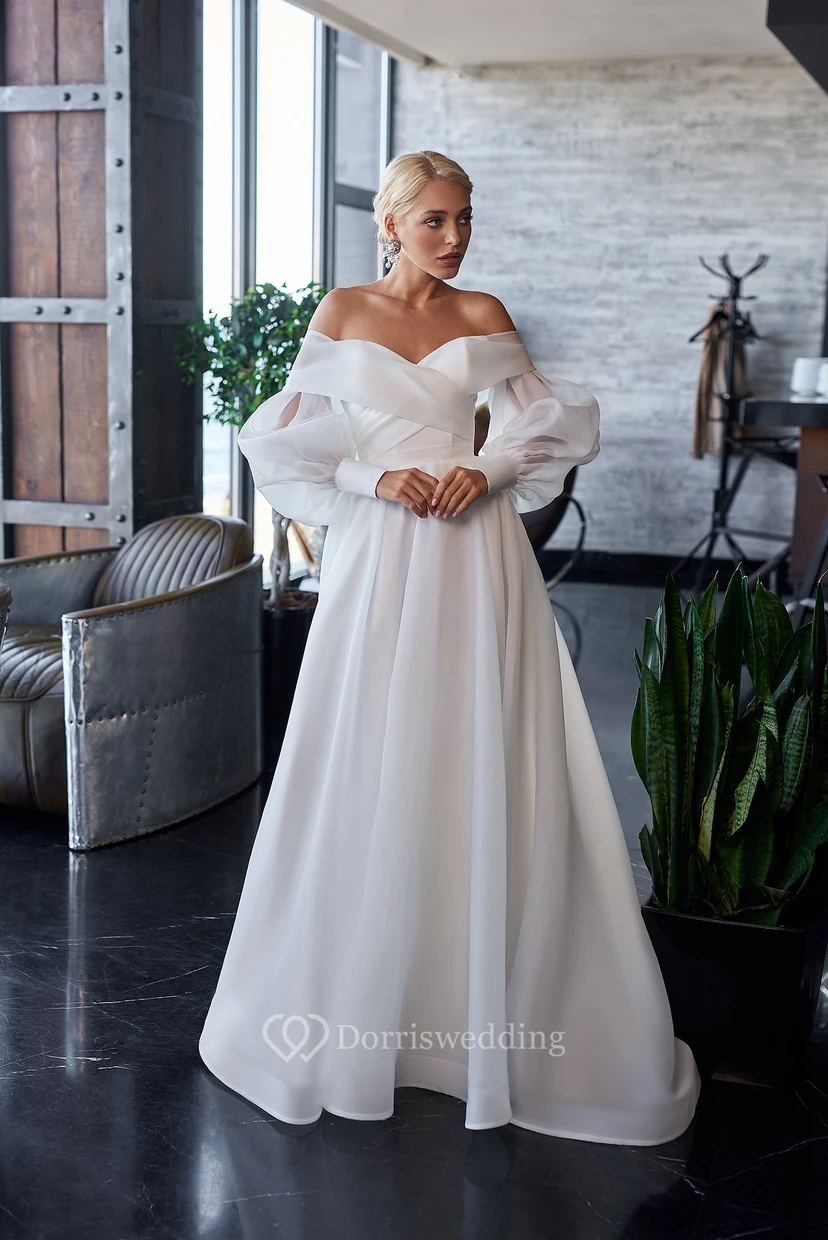 Vestido de novia sencillo de corte A, manga larga abullonada, estilo imperio, con detalle cruzado.