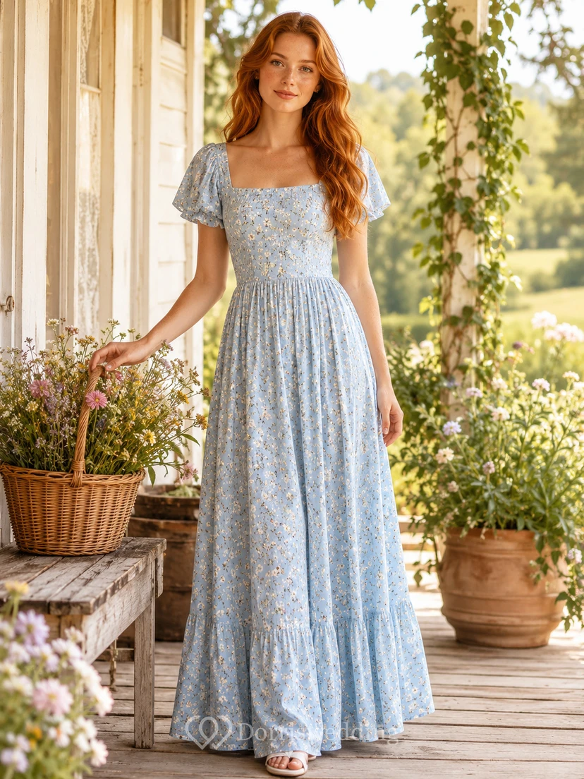 Vestido largo azul con cuello cuadrado y mangas abullonadas, estampado floral estilo cottagecore.