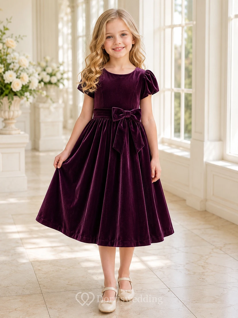 Robe de demoiselle d'honneur en velours prune, coupe trapèze, manches bouffantes, nœud et jupe plissée