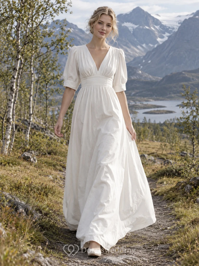 Vestido de novia de corte A estilo imperio en popelina de algodón con escote en V y mangas abullonadas con puños hasta el codo.