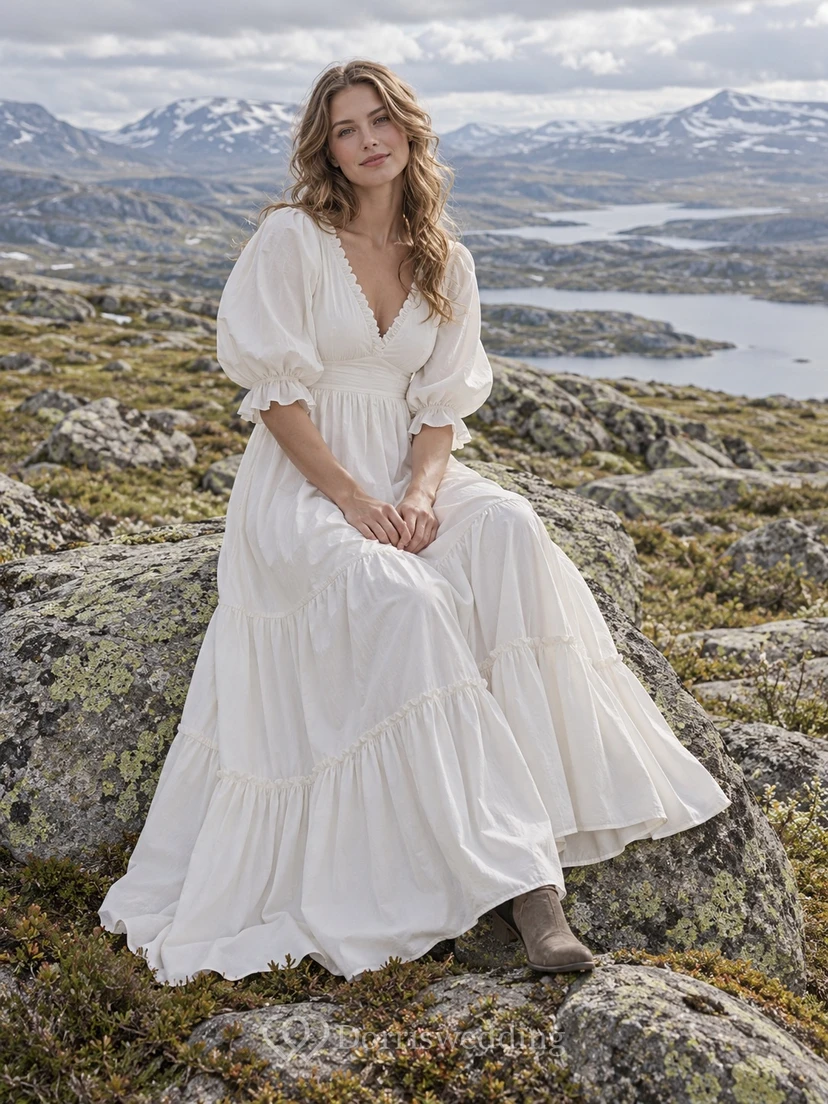 Vestido de novia bohemio de popelina de algodón con escote en V, corte en A, mangas abullonadas y falda escalonada.