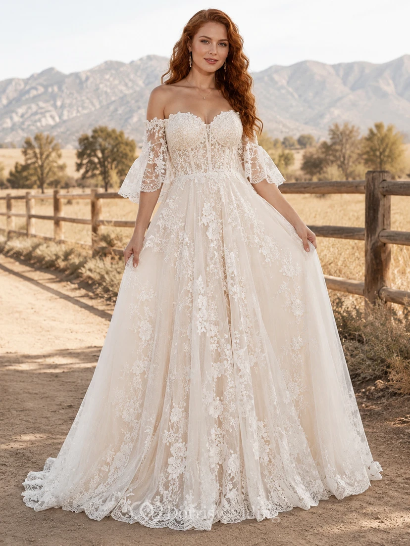 Robe de mariée champêtre en tulle, coupe trapèze, épaules dénudées, manches bouffantes, traîne chapelle, dos corset lacé
