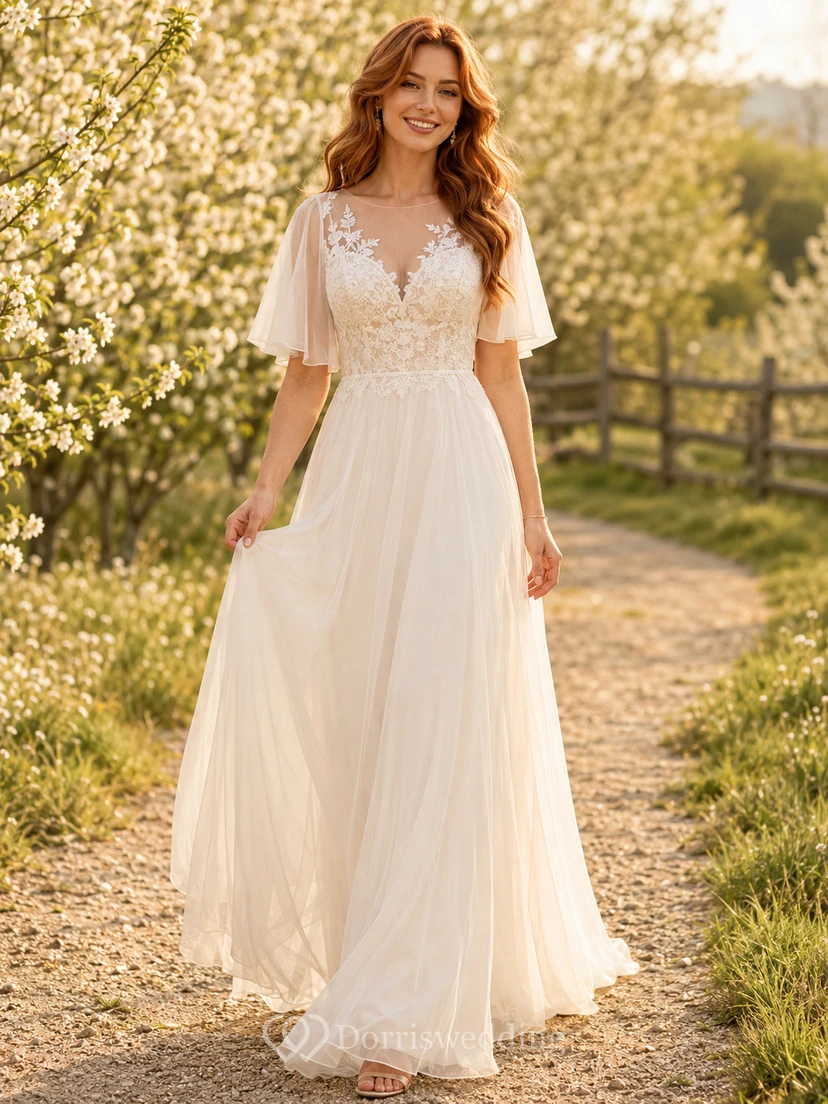 Vestido de novia campestre de tul, corte en A, escote en V, mangas con volantes, cola larga y espalda baja en V.