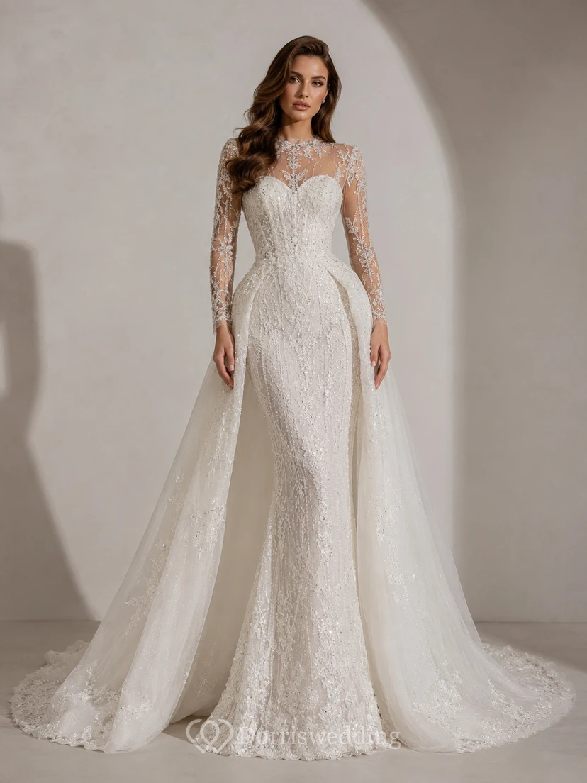 Robe de mariée cape en satin et dentelle botanique, col montant, manches longues et traîne cathédrale, style illusion, pour une destination de mariage.