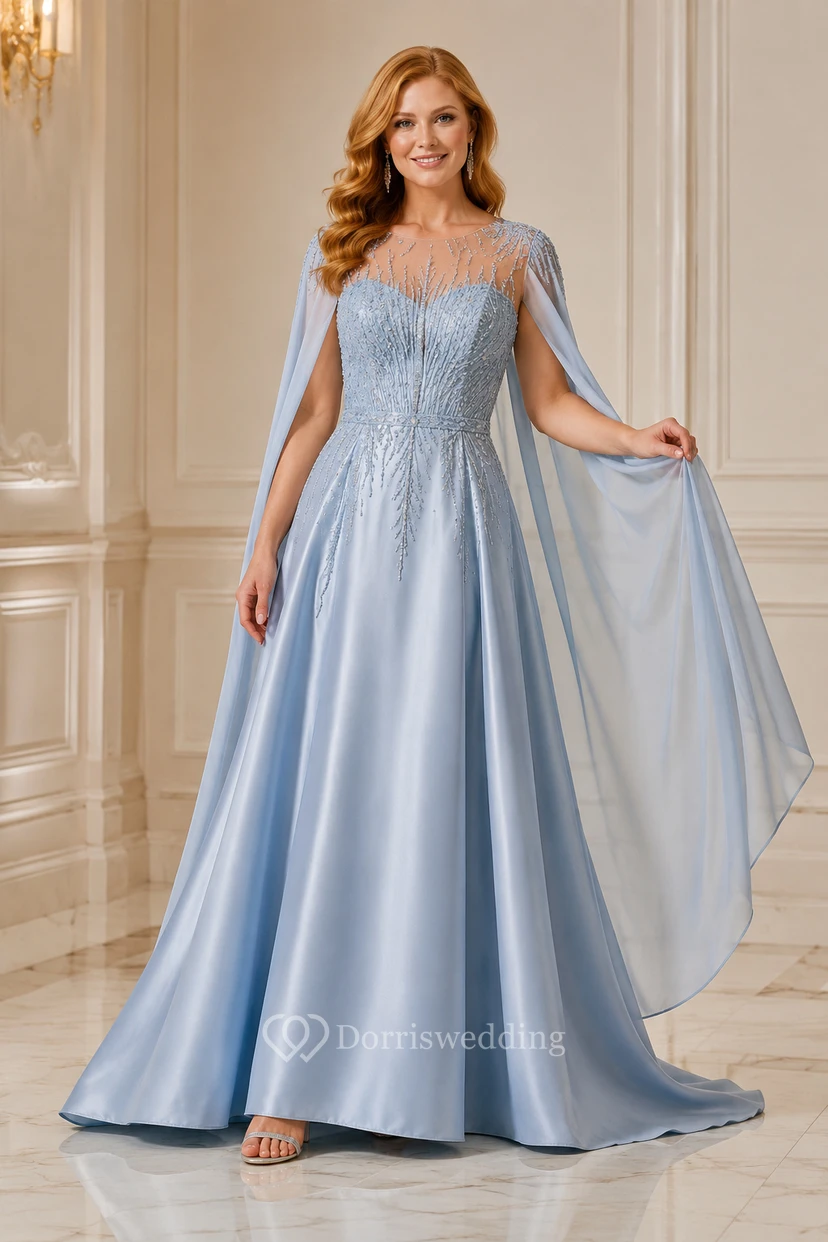 Robe de soirée bleu acier à manches cape et corsage illusion orné de perles
