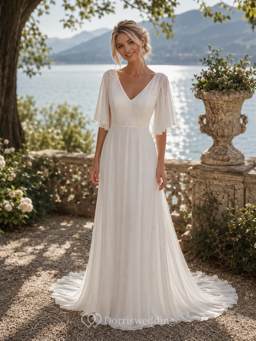 Vestido de novia de gasa con escote en V y mangas tres cuartos, estilo imperio.
