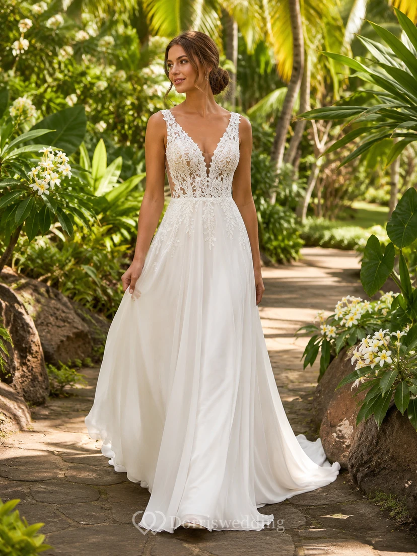 Robe de mariée bohème en mousseline de soie à décolleté plongeant et dentelle, coupe trapèze, style champêtre, pour un mariage de destination.